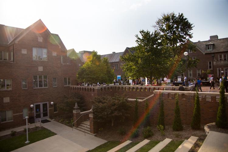 students milling around the career fair booths in the courtyard of Bloch Heritage Hall