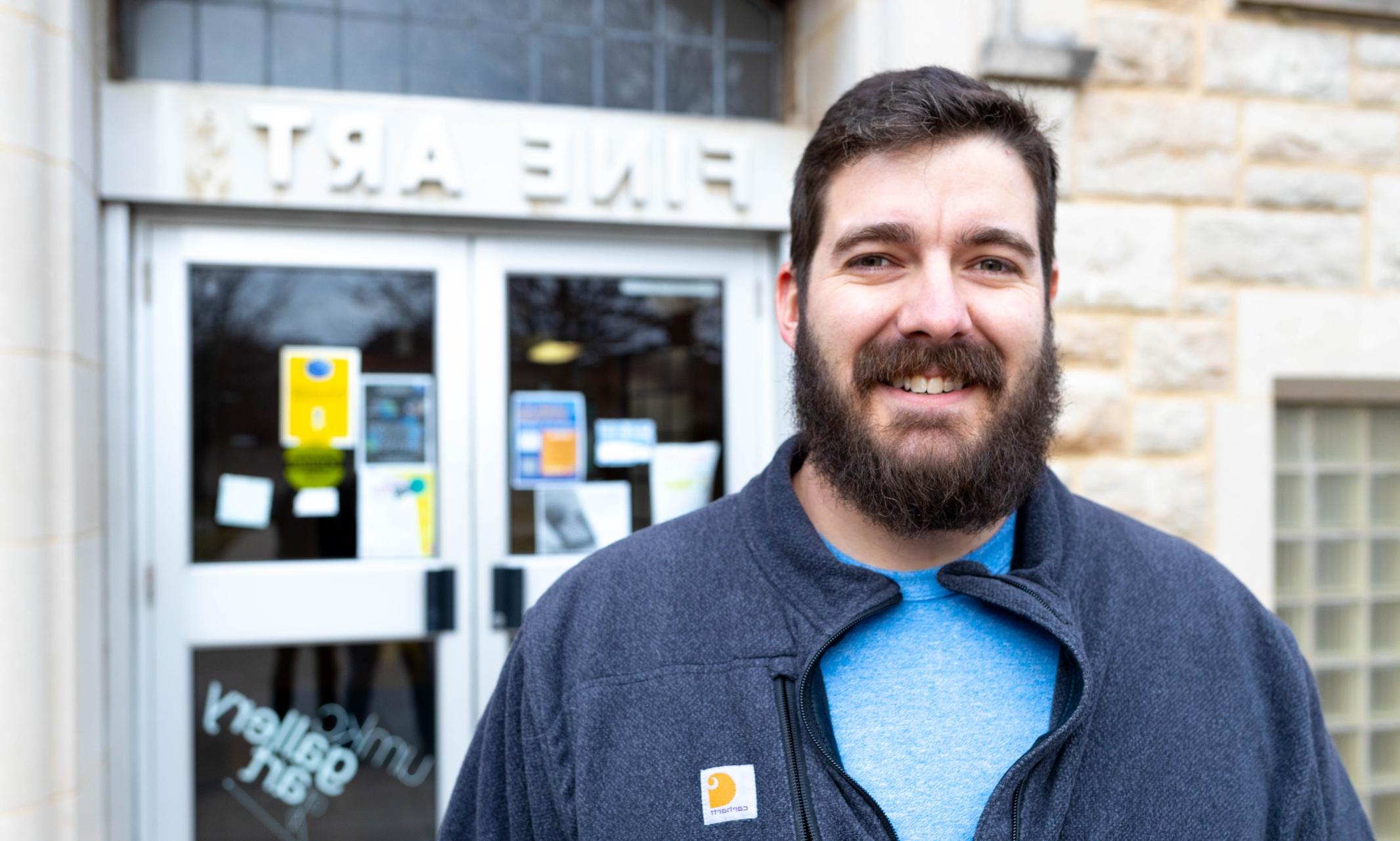 Eric Quinones stands in front of the Fine Arts building