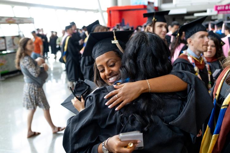 A graduate hugs their family member after the commencement ceremony